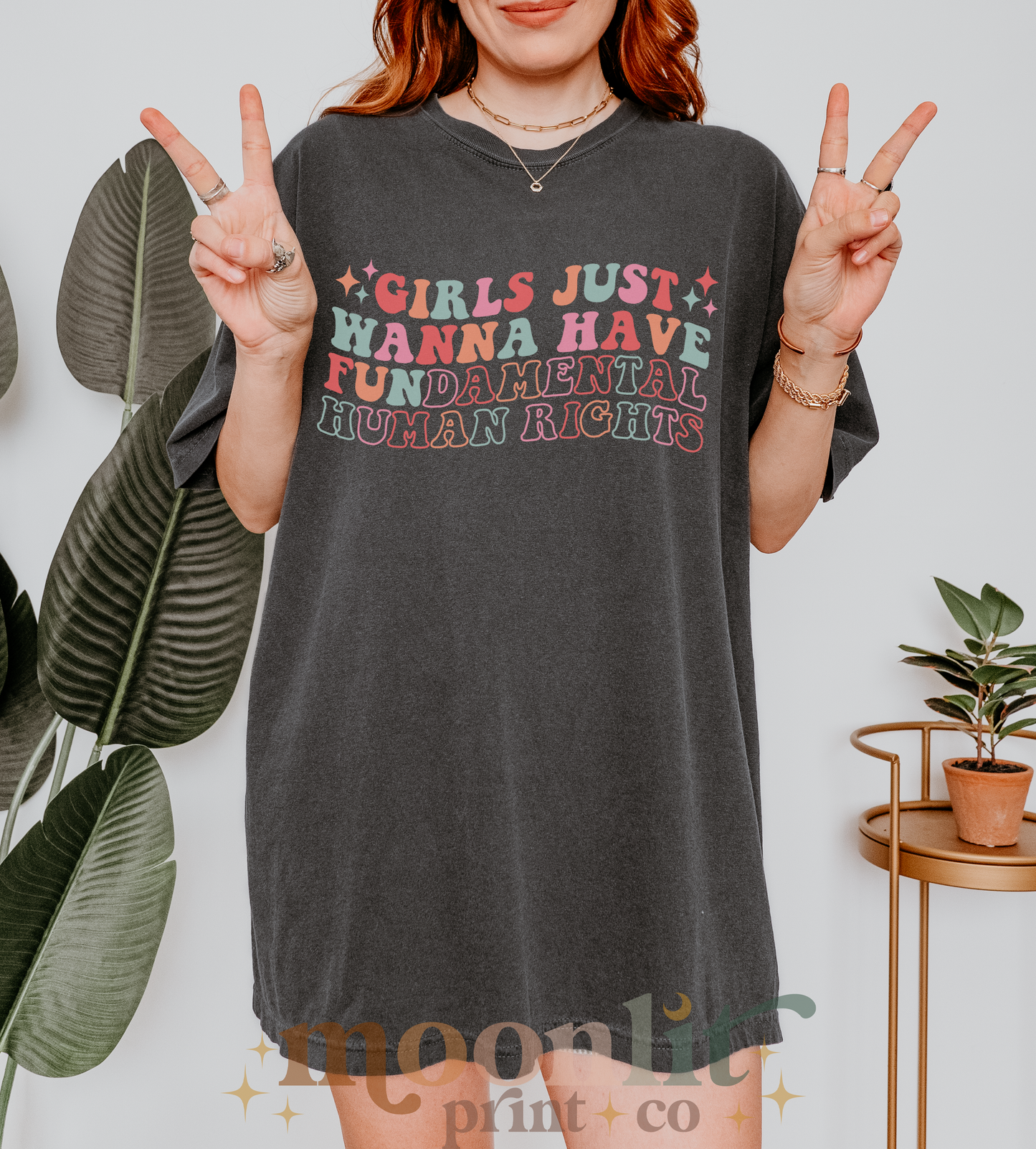 a woman wearing a shirt that says girls just wanna't have fun in the