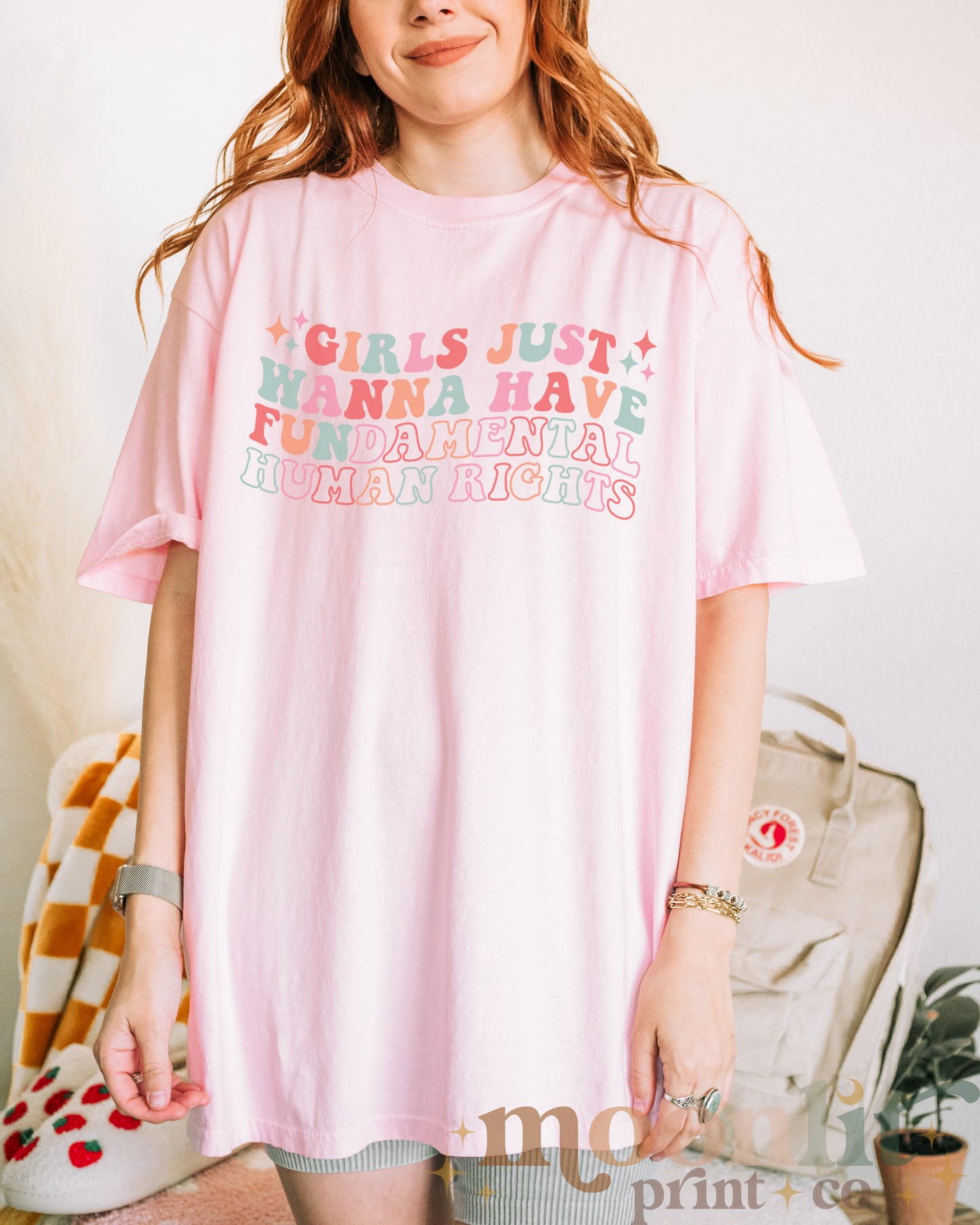 a woman wearing a pink t - shirt with the words girls just wanna have fun