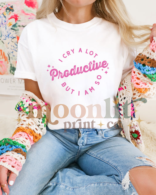 a woman sitting on a bed wearing a white t - shirt with crochet