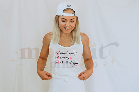 a woman wearing a white tank top and shorts