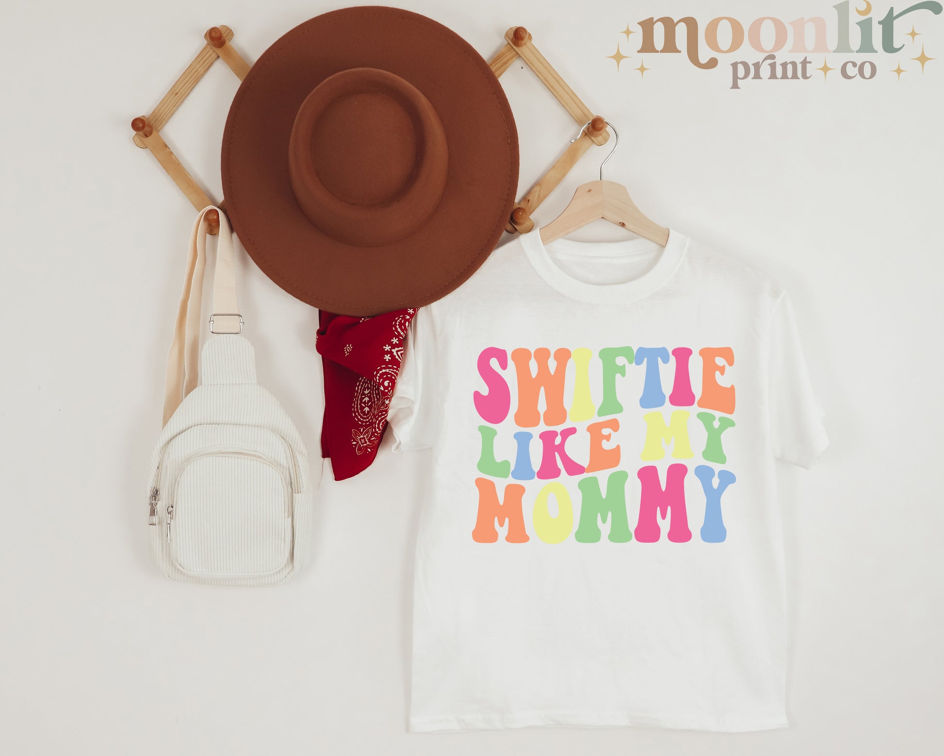 a hat, a t - shirt, and a fanny bag on a white background