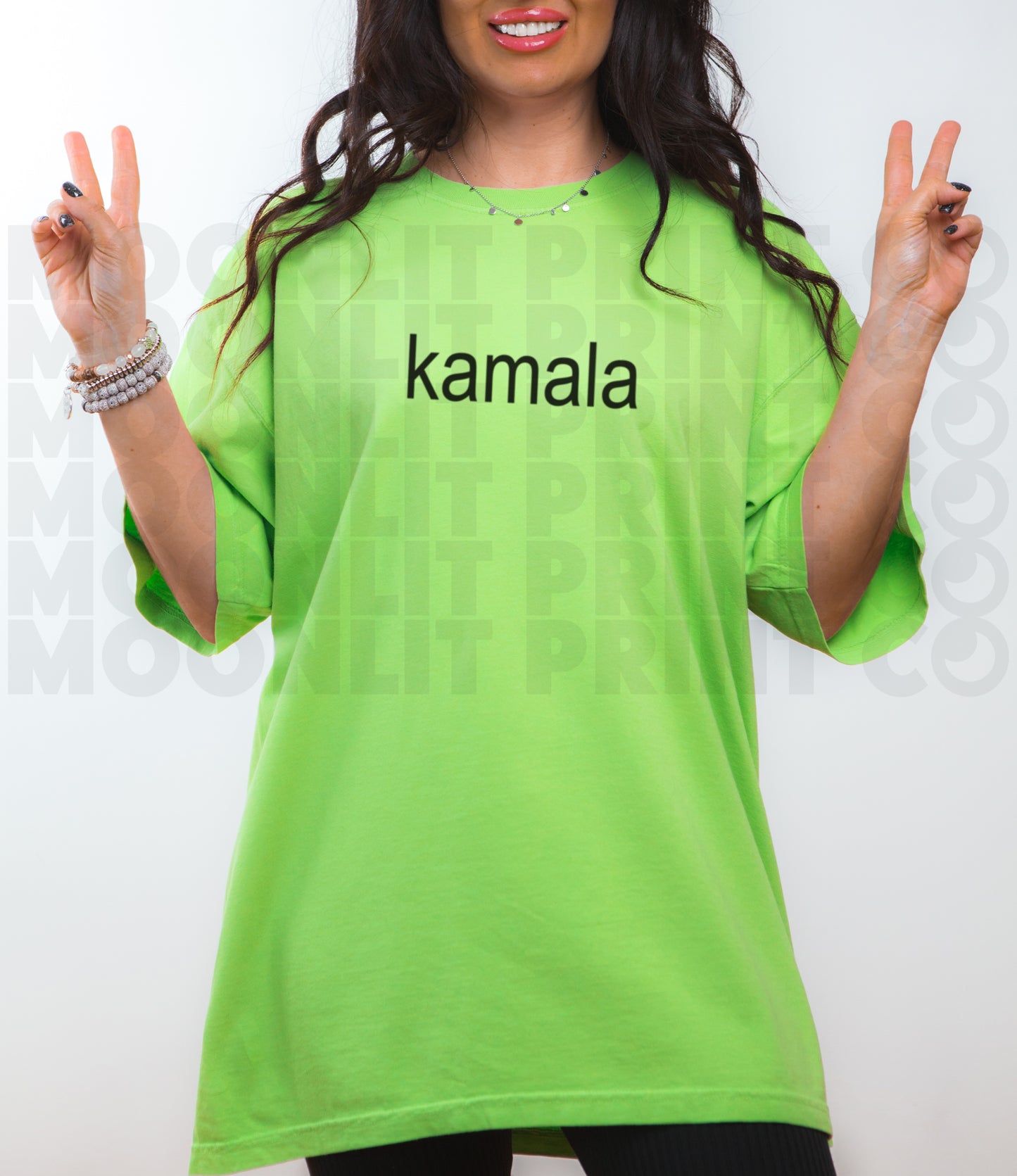 a woman in a green shirt is making a peace sign