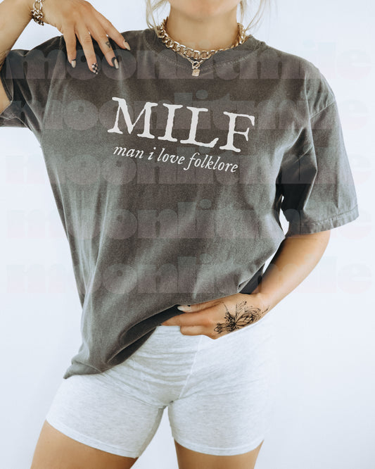 a woman wearing a t - shirt that says milf