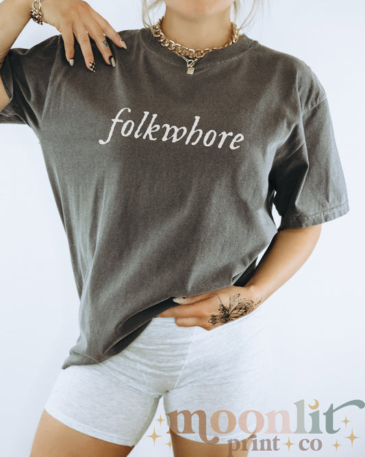 a woman wearing a t - shirt with the word folkloremore on it