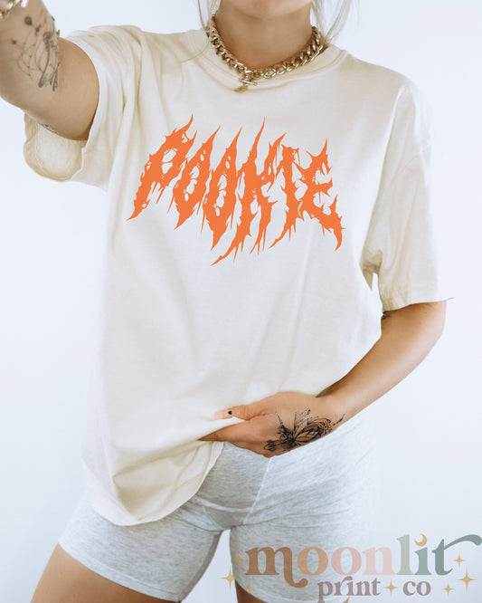 a woman wearing a white shirt with orange writing on it