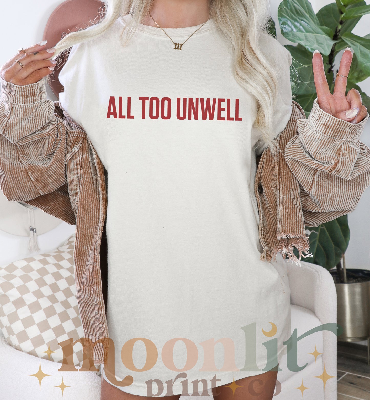 a woman wearing a t - shirt that says all too unwell