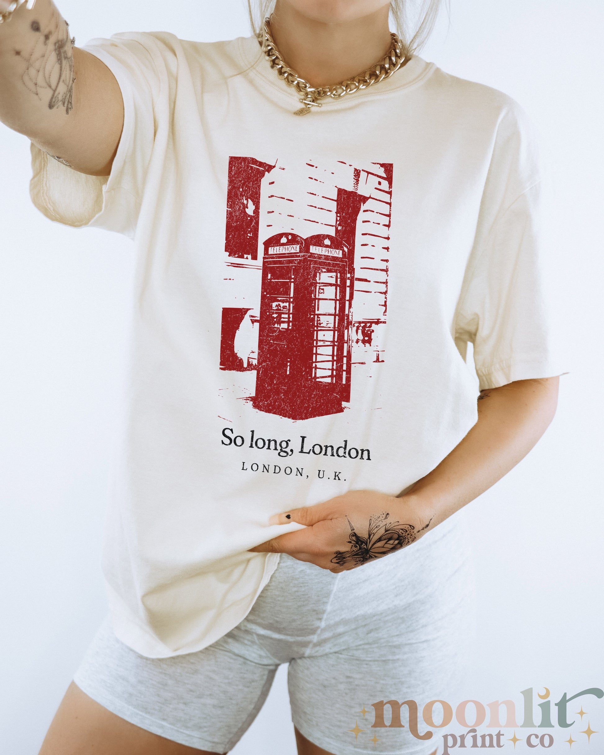 a woman wearing a t - shirt with a picture of a phone booth on it