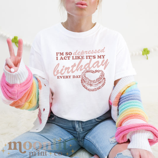 a woman sitting on the floor making a peace sign