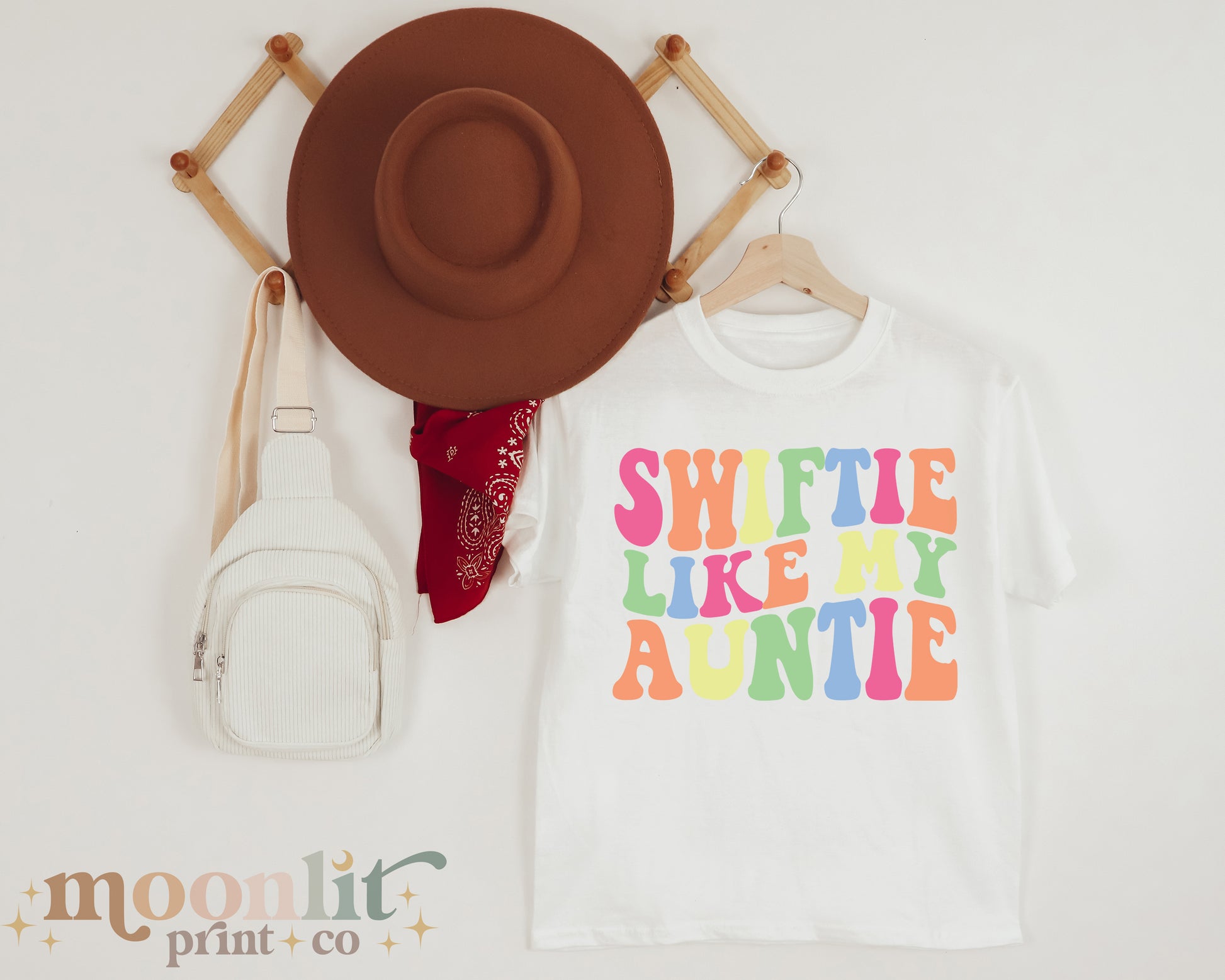 a hat, a t - shirt, and a purse are on display