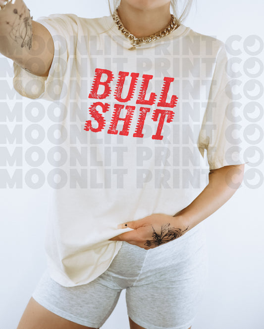 a woman wearing a bull shit t - shirt and shorts