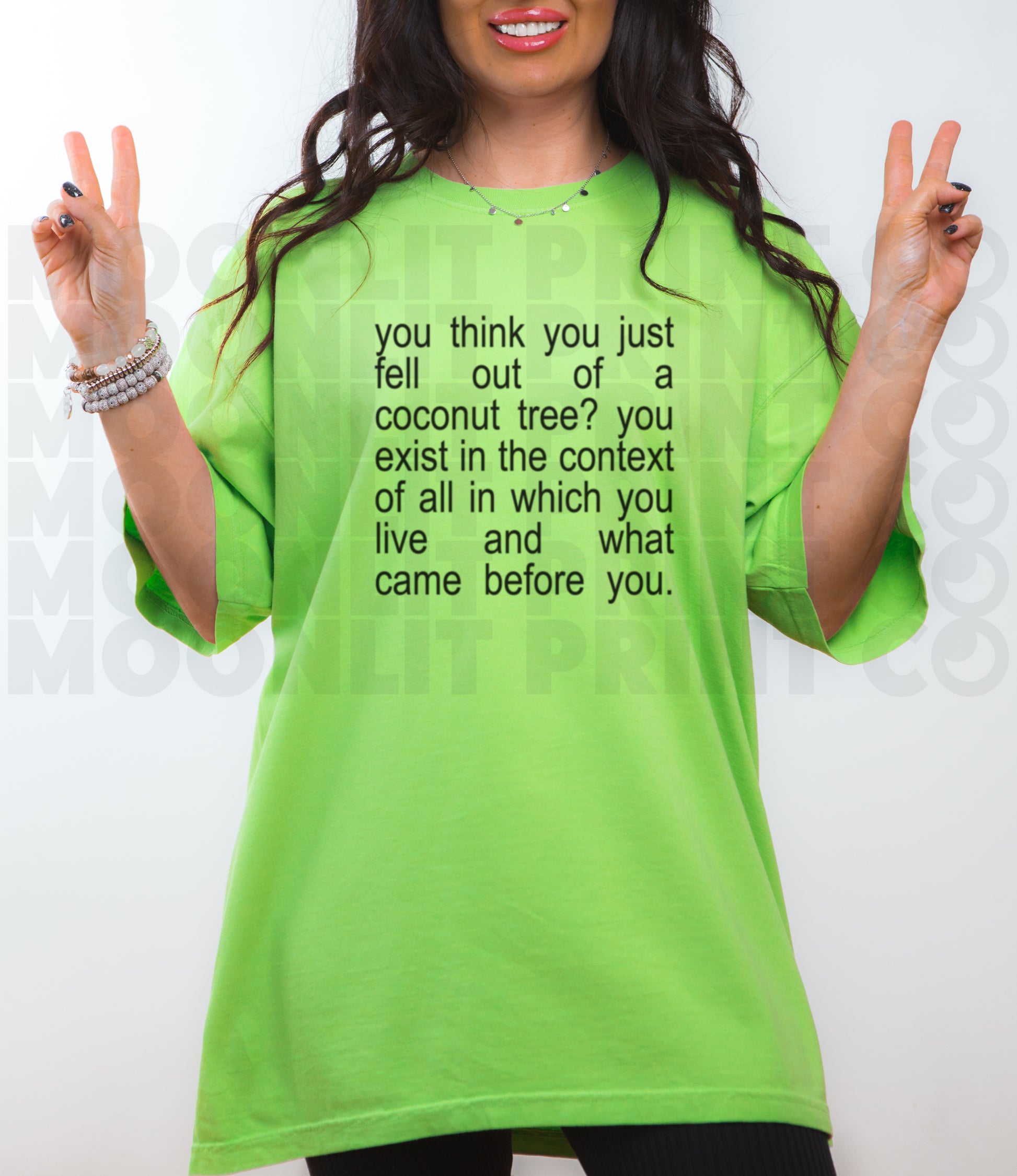 a woman in a green shirt is making the peace sign