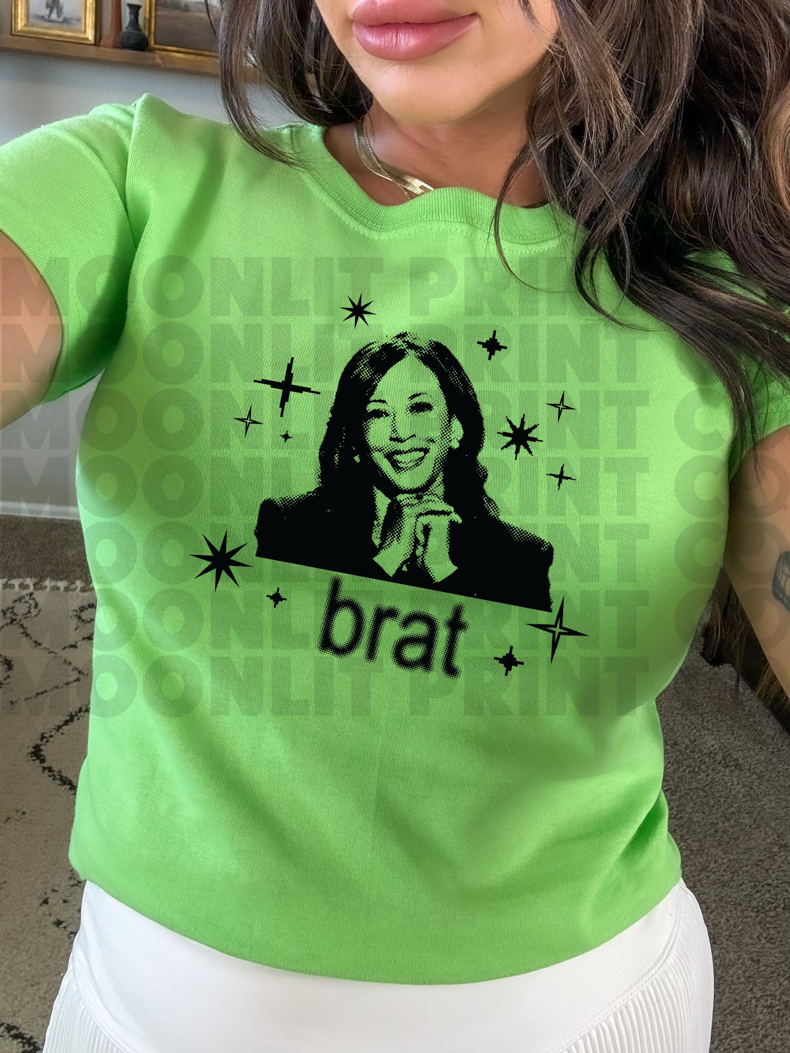 a woman wearing a green shirt with a picture of a woman on it