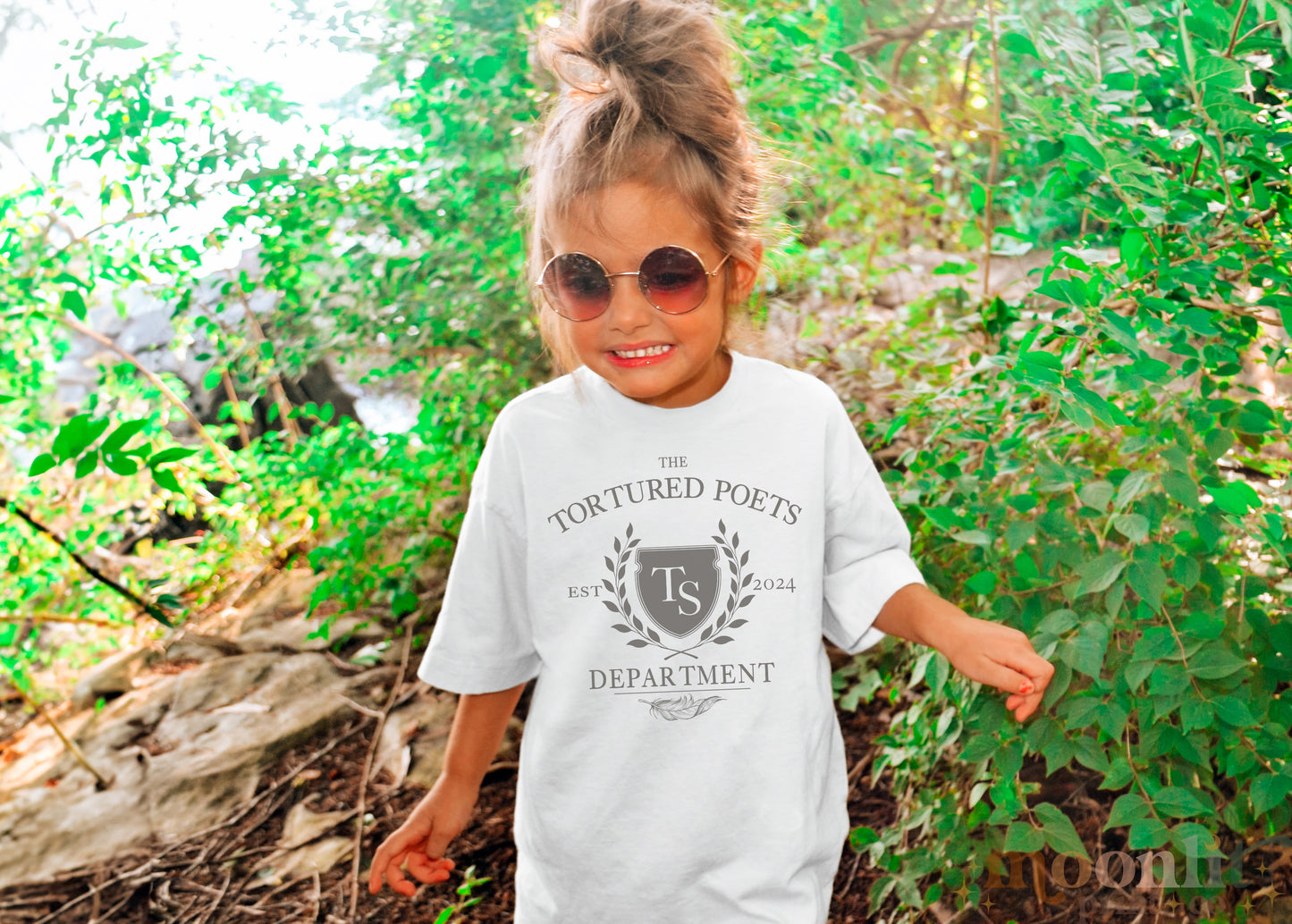 a little girl wearing a white shirt and sunglasses