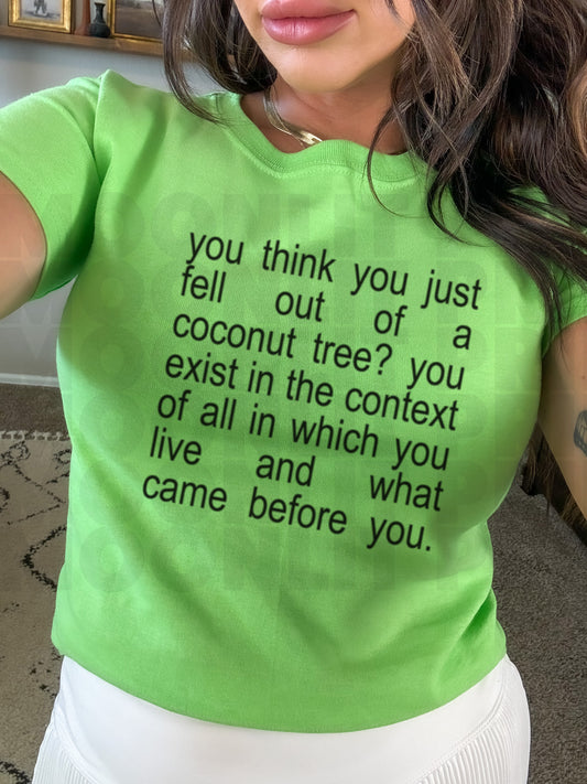 a woman wearing a green shirt with a quote on it