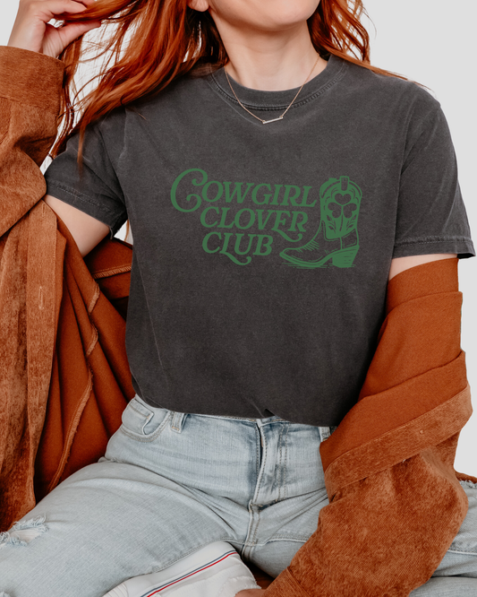 a woman wearing a cowgirl clover club t - shirt